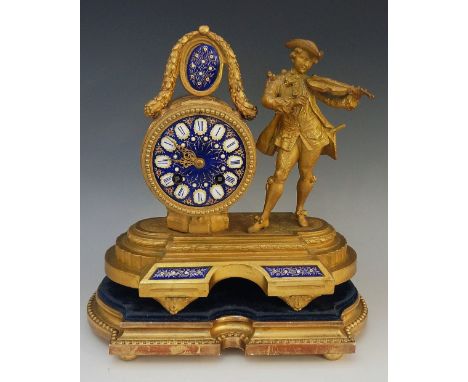 A mid Victorian ormolu mantel clock, the drum shaped case with blue enamelled jeweled dial with Roman numeral tablets, flanke