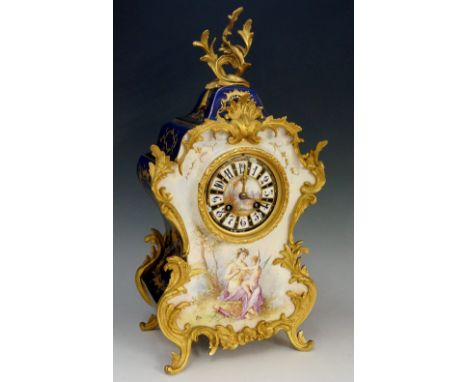 A good Sèvres porcelain mantel clock of cartouche shape, applied ormolu foliate mounts, the circular dial painted to the cent