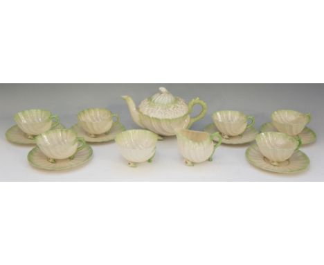 A Belleek Neptune pattern tea service, green tinted, comprising teapot, cream jug, sucrier and six cups and saucers, teapot 2