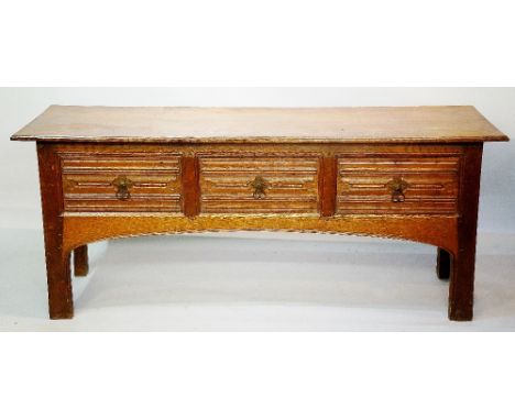 Robert Lorimer? - an oak sideboard, the over sailing rectangular top above a frieze, fitted three drawers carved with horizon