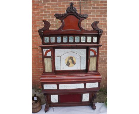 A late 19th / early 20th Century coin-in-the-slot barrel organ, contained within an ornate stained mahogany architectural cas