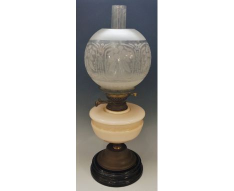 A Victorian oil lamp with pink glass reservoir and acid etched frosted globular shade, black ceramic base, late 19th Century 