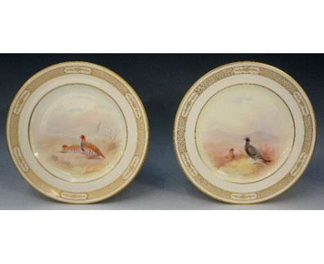 A pair of Royal Doulton cabinet plates painted to the centres with black grouse and partridge by T. Wilson, the ivory borders