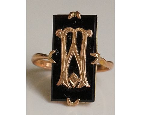 A 9ct gold and jet Memoriam ring, the rectangular jet tablet claw set and applied a monogrammed initial, rose gold shank mark