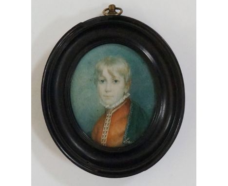 An early 19th Century portrait miniature, head and shoulder portrait of a young boy wearing green cloak and red jacket with r