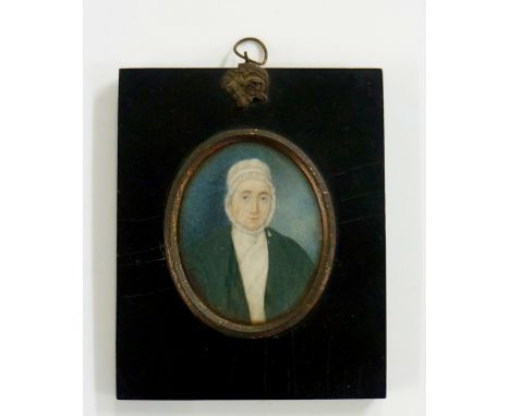 A 19th Century oval portrait miniature, head and shoulders of an elderly woman wearing bonnet and green coat, watercolour on 