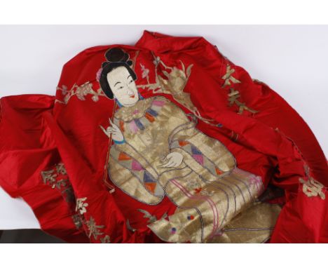 A large red silk Chinese wall hanging, with a central appliqué female figure with a small deer to her side, her costume is wo