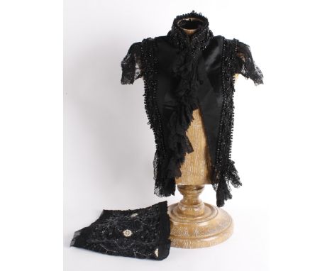 A 19th century black satin and grosgrain shoulder cape, edged with black lace to the front and shoulders, a heavy glass beade