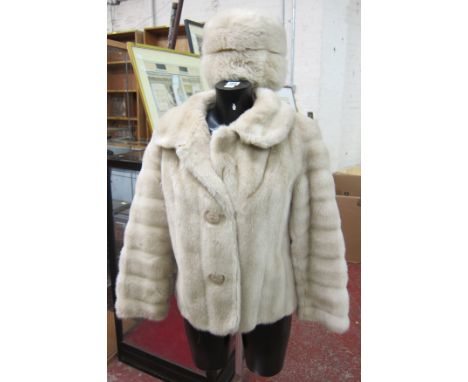 A vintage faux fur cream coat and matching hat by Tissavel.
