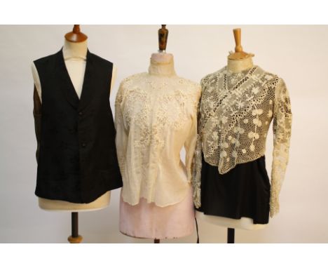 An Edwardian cream lace blouse; together with an Irish crochet blouse attached to a black silk top (acting as a lining); and 