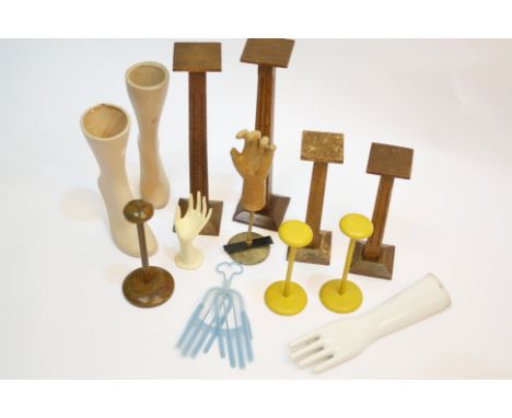 A set of 1930s wooden shop display hatstands; together with a composition glove display stand, three smaller display stands, 
