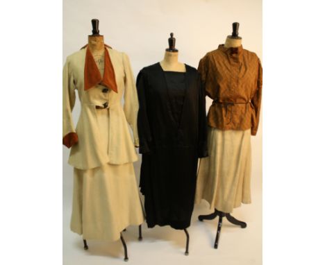 An Edwardian cream wool skirt and jacket, an early 20th century black satin evening dress, an Edwardian cream silk blouse wit