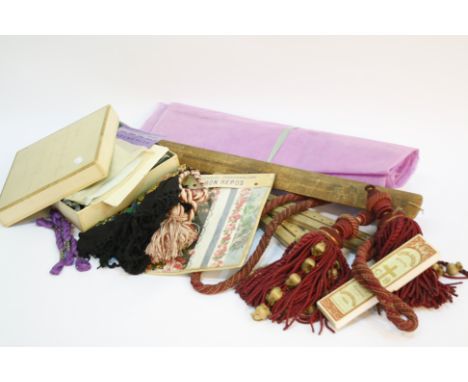 Two bolts of French mauve coloured unused hat gauze, with a floral fabric sample book, a pair of tailor's wooden trouser stre