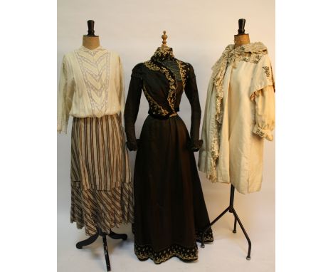 A late 19th century dark green two-piece costume with appliqué detail; a cream Victorian silk and velvet coat trimmed with la