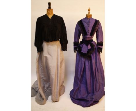 A 19th century mauve silk costume, a Victorian Brown & Co. of Chester black pleated silk blouse, a striped purple blouse, a m