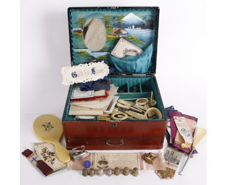 A lacquered sewing box and contents, including: a quantity of thimbles, a novelty tape measure in the form of a miniature iro