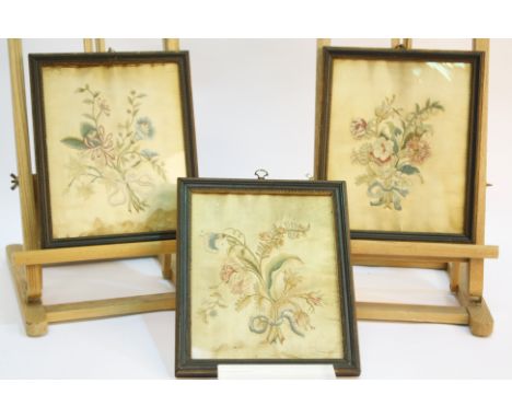 Three early 19th century framed and glazed embroidered pictures, each panel showing a small bouquet of embroidered flowers he