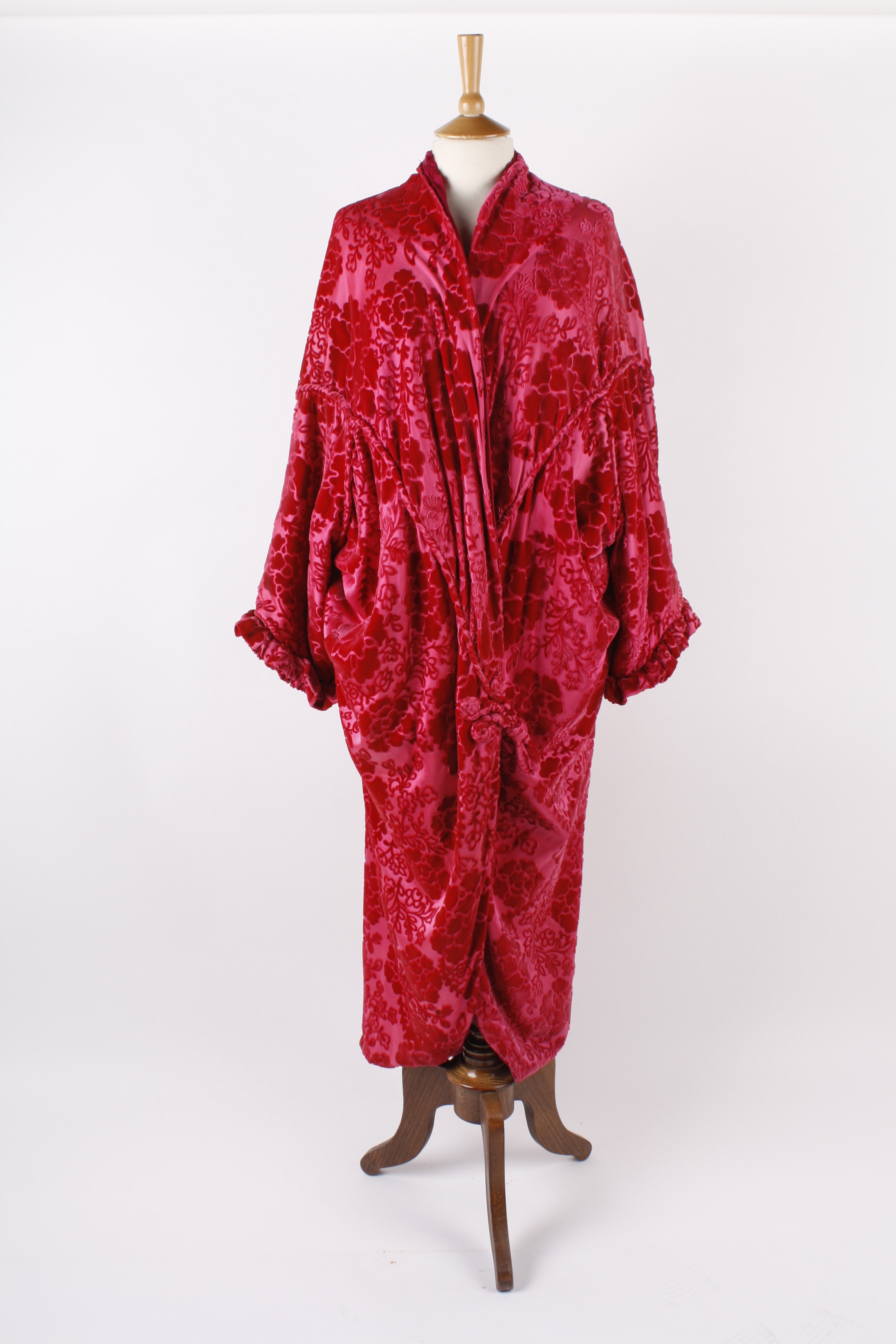 A 1920s pink devoré opera coat; together with a black devoré evening