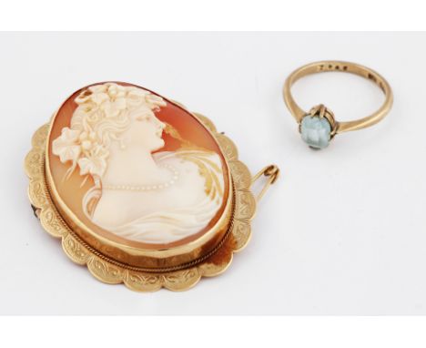 A cameo brooch of a female portrait in profile, mounted in a hallmarked 9ct gold mount with engraved decoration to border wit