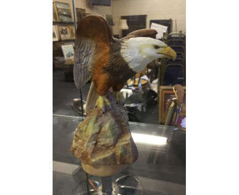 A ceramic Bald Eagle figure in matt glaze finish by E R Booth, signed to base.