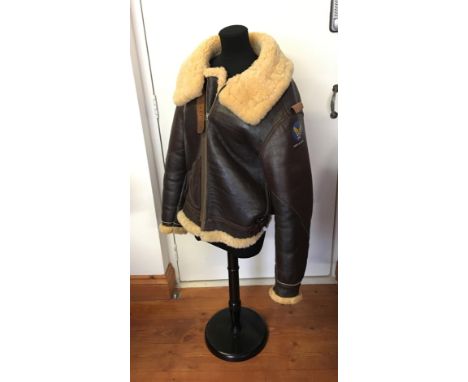 A brown leather and sheep's wool flying jacket, bears label for Eastman Leather Clothing, Type B-3, with transfer printed Arm