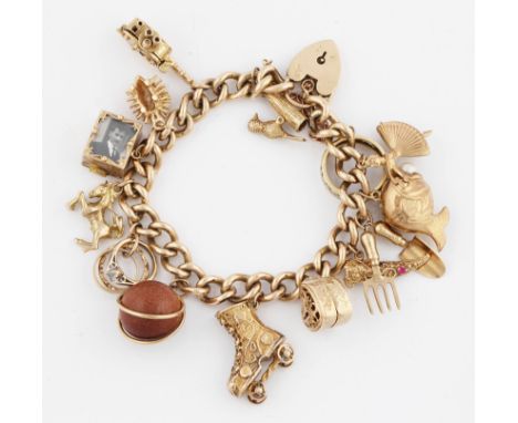 A 9ct gold charm bracelet fitted with 17 charms including; woodpecker, camera, hedgehog, photo holder, rearing horse, three r