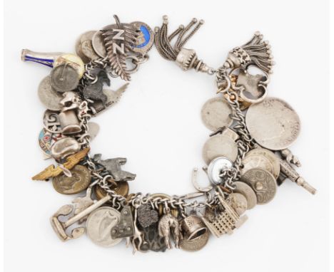 A white metal curb link bracelet, suspending numerous charms to include enamel examples, a monkey, a 9ct elephant etc.