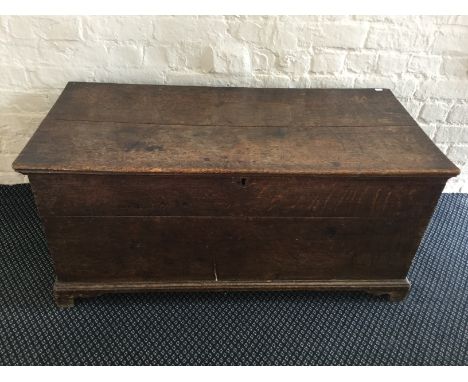 An oak blanket box on bracket feet.