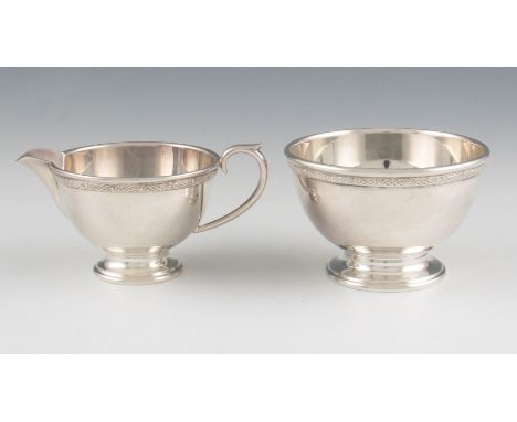 A Liberty & Co silver plated milk jug and sugar bowl, each having Celtic design band to collars with alternating plus and cir