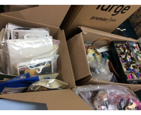 Two boxes containing embroidery kits and needlework items including a case of thread and various tools.