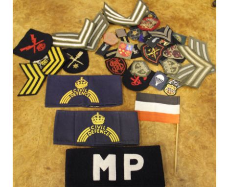 A collection of assorted military cloth insignia, mostly British including air force, naval and army examples plus MP armband
