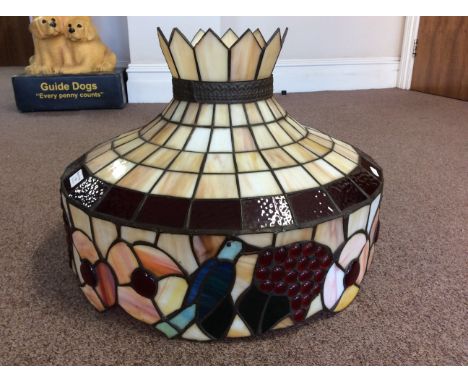 A Tiffany style ceiling light fitting with blue bird and berry decoration and crown top.