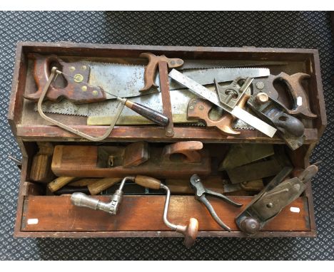 A tool box with various tools together with a travel trunk.
