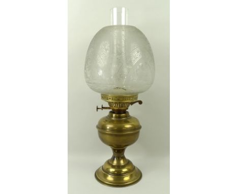 A brass oil lamp with a clear etched glass shade and double burner, 48cm. 