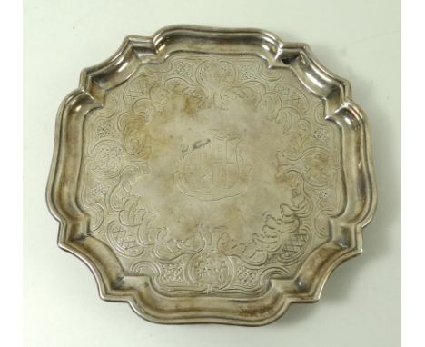 A George I silver salver, London 1726, John Tuite, of square form with incuse corners, with Chippendale scroll rim and an arm