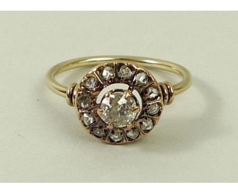 A diamond and gold ring, the central diamond of approximately 0.5ct, surrounded by a circle of twelve diamonds, size K, 2.2g 