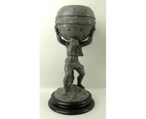 A pewter atlas, raised on a turned ebonised round base, the hero holding a celestial globe, with a band of astrological signs