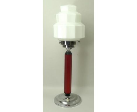 An Art Deco table lamp, with geometric shape milk glass shade, with hexagonal maroon stem on a round stepped base, 48cm. 