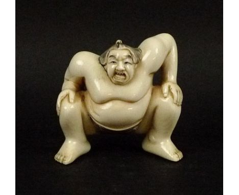 A late 19th/early 20th century Japanese ivory netsuke, modelled as a sumo wrestler, signed to base, 4.5cm high.