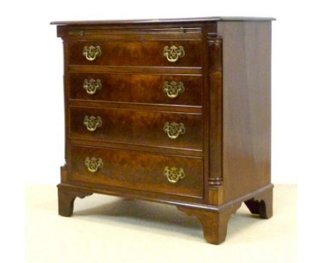 A reproduction mahogany chest of four drawers, mid 20th century, with moulded edge to the surface over a brushing slide, pier