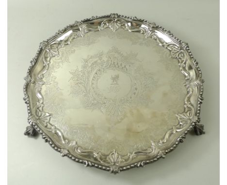 A silver salver, with cast bead and leaf rim, the reserve with a griffin, on ball and claw feet, Sheffield 1853, R&H, 19.94to