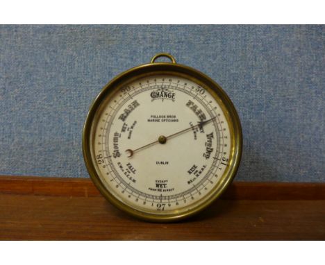 A small brass marine clock, the dial signed Pollock Bros. Marine Opticians, Dublin 