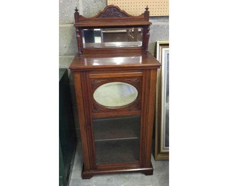 An early 20th century mahogany cabinet with display shelf, oval mirror to door and mirror & shelf to top. Size 55cm wide, 119