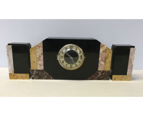 An Art Deco marble clock and garniture.