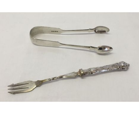 A Victorian silver pair of sugar tongs London 1855 with a silver handled pickle fork Birmingham 1908. Total weight (including