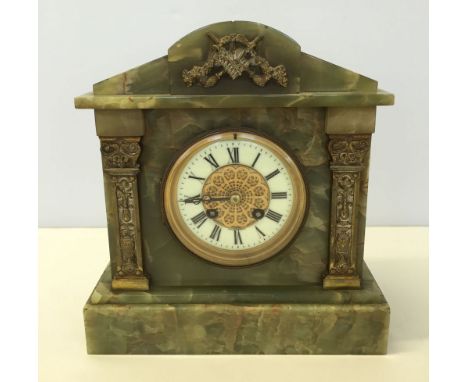 A Victorian green marble mantle clock.