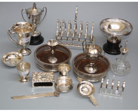 A silver tea strainer and base, a silver five arch toastrack, a match box cover and a quantity of other silver and silver pla