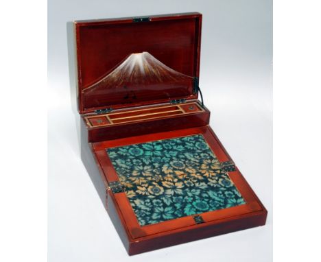 An early 20th century Japanese red lacquer painted writing slope, the hinged lid with black lacquer and Mother of Pearl Chino
