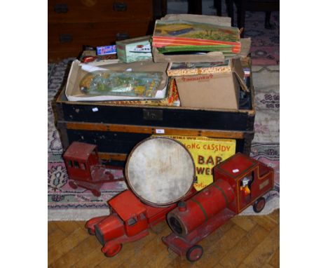 A 19th century dome top trunk containing a collection of largely mid 20th toys and juvenalia including a Tri -Ang flatbed tip