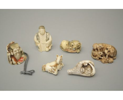 A group of six tagua and other netsuke, including cat with carp, horse and rat, eagle talon and money etc